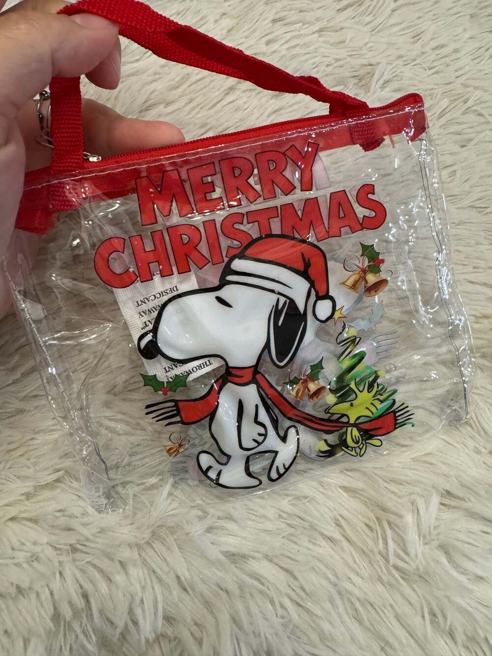 Snoopy clear pouch Christmas bag with red trim and Snoopy wearing a Santa hat